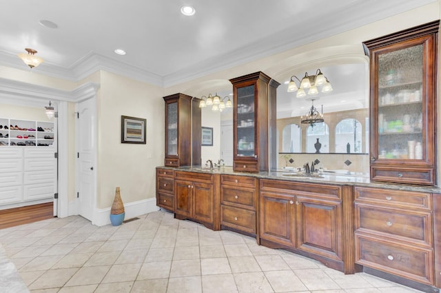 bathroom with vanity, tile patterned floors, and crown molding