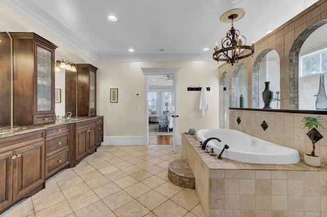 bathroom featuring tile patterned flooring, a relaxing tiled tub, vanity, ceiling fan with notable chandelier, and ornamental molding