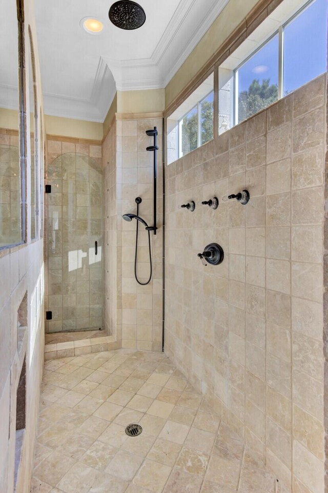 bathroom with a tile shower and ornamental molding