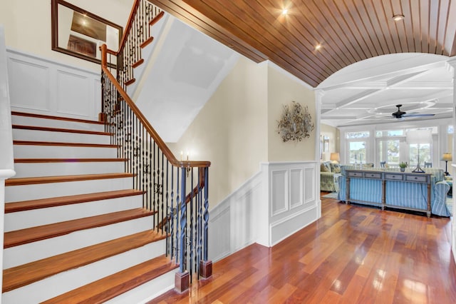 stairway featuring hardwood / wood-style floors, ceiling fan, and wood ceiling