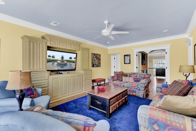 living room with ceiling fan, crown molding, and dark wood-type flooring