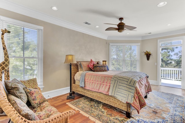 bedroom featuring access to exterior, ceiling fan, light hardwood / wood-style flooring, and multiple windows