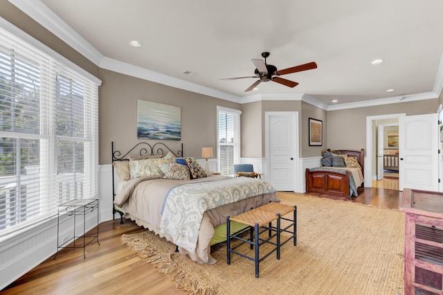 bedroom with ceiling fan, light hardwood / wood-style flooring, and crown molding