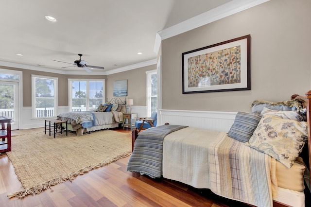 bedroom featuring wood-type flooring, ceiling fan, and ornamental molding