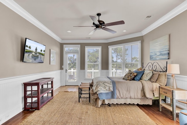 bedroom with access to outside, ceiling fan, wood-type flooring, and ornamental molding