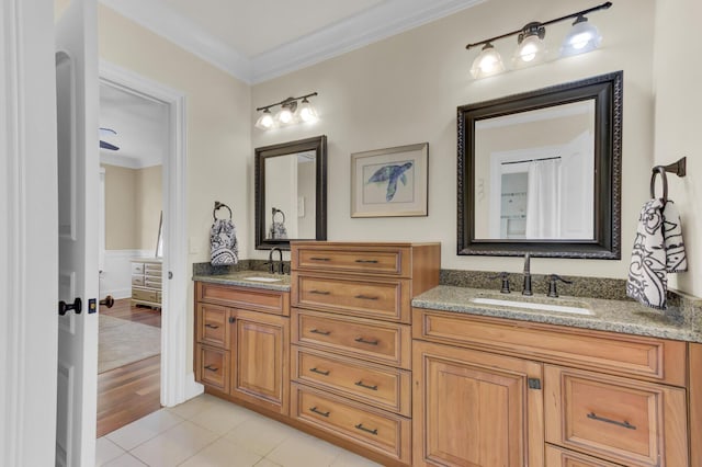 bathroom with tile patterned flooring, vanity, and ornamental molding