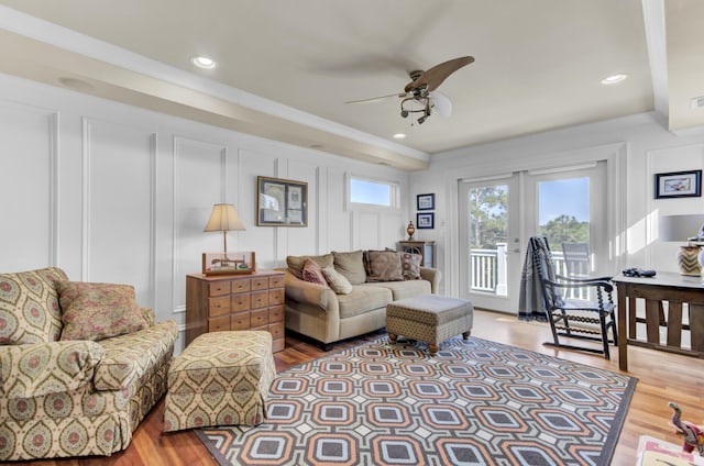 living room featuring french doors, light hardwood / wood-style floors, ceiling fan, and crown molding