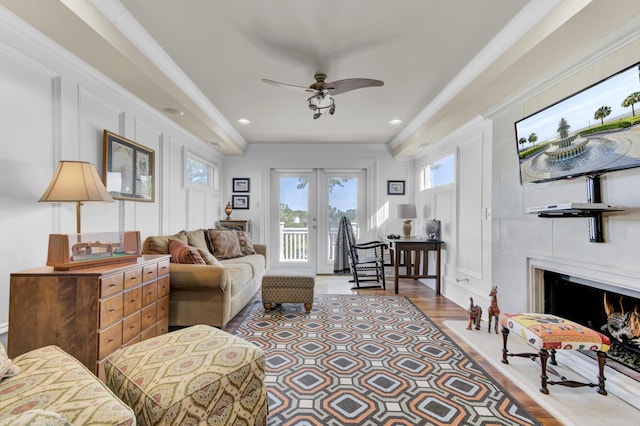 living room featuring ceiling fan, light hardwood / wood-style flooring, crown molding, and french doors