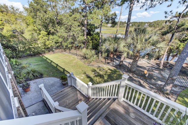 wooden deck featuring a lawn and a patio