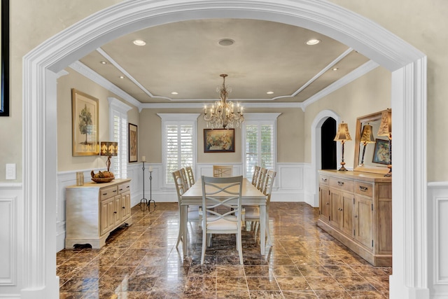 dining space featuring a chandelier and crown molding