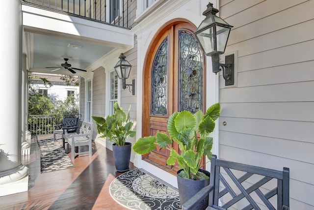 doorway to property featuring ceiling fan, a porch, and a balcony