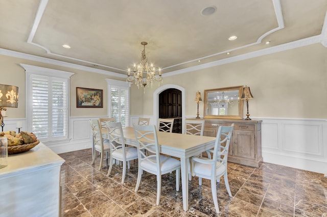 dining room with a chandelier and crown molding