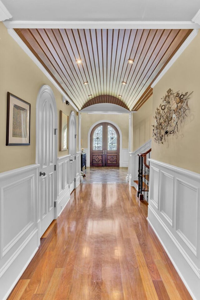 foyer entrance featuring french doors, light hardwood / wood-style flooring, and ornamental molding