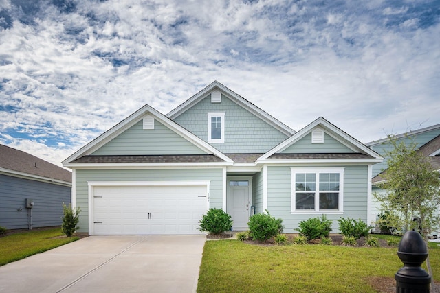 craftsman-style home with a garage and a front lawn