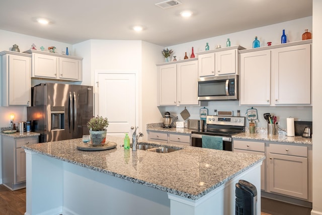 kitchen featuring a center island with sink, stainless steel appliances, and sink