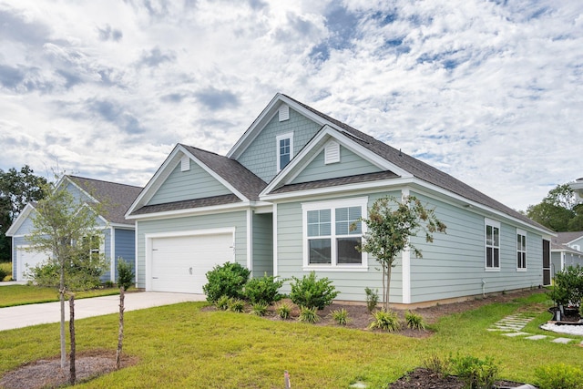 view of front of house featuring a garage and a front lawn