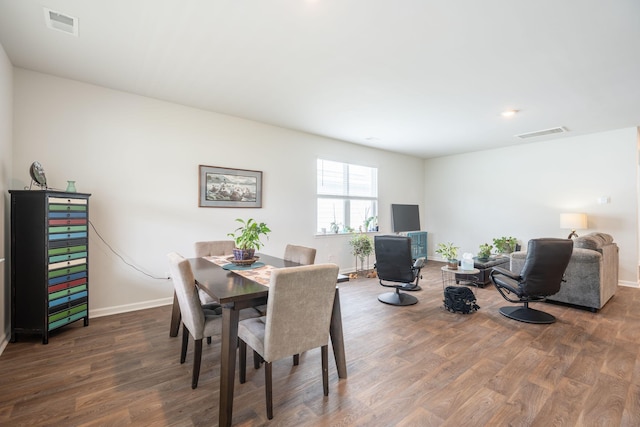 dining room with dark hardwood / wood-style flooring