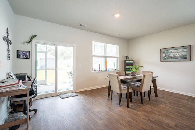 dining room with dark hardwood / wood-style floors and a healthy amount of sunlight