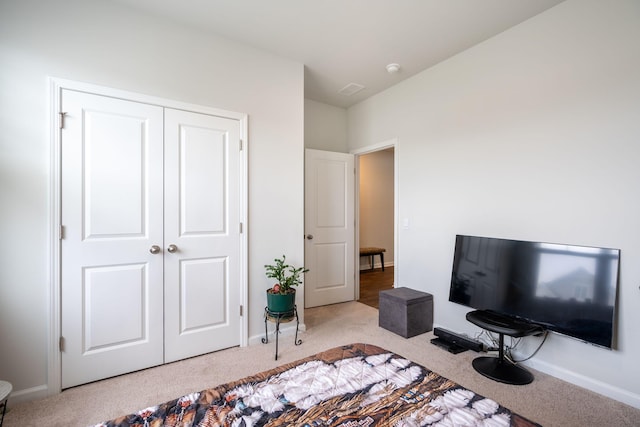 carpeted bedroom with a closet