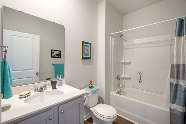 full bathroom featuring shower / tub combo with curtain, hardwood / wood-style floors, vanity, and toilet