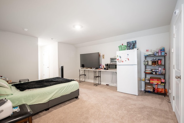 bedroom featuring white refrigerator and light colored carpet