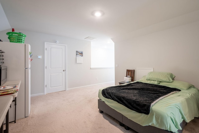 carpeted bedroom with white refrigerator and lofted ceiling