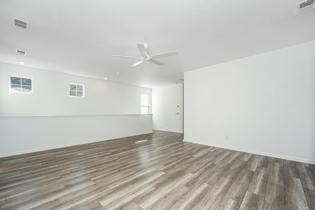 spare room with hardwood / wood-style floors and ceiling fan