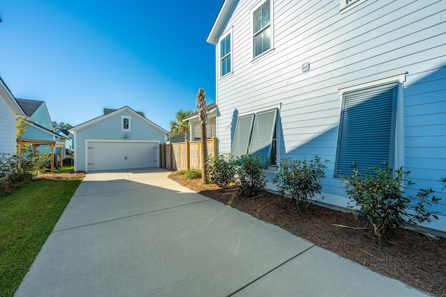 view of property exterior with an outdoor structure and a garage