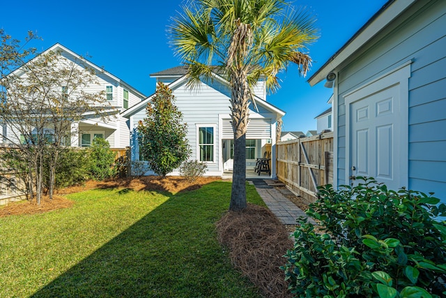 back of house featuring a lawn and a patio