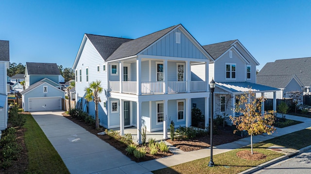 view of front of house featuring a porch, a balcony, a garage, and an outdoor structure