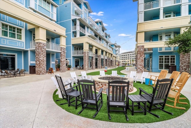 view of home's community featuring a patio and an outdoor fire pit