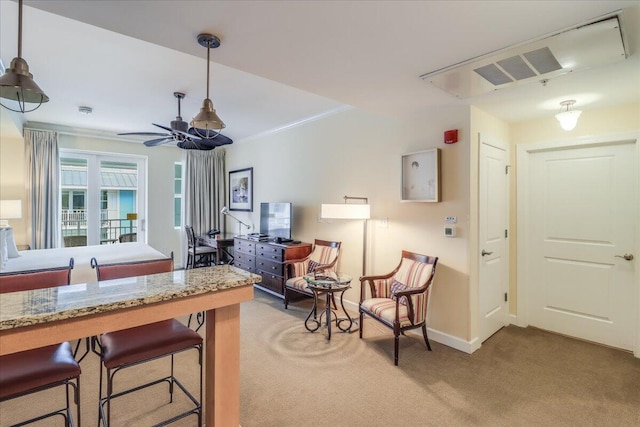 kitchen featuring hanging light fixtures, carpet, and a breakfast bar