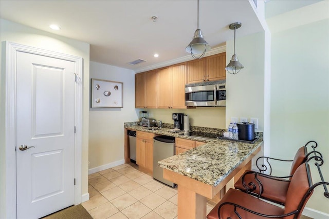 kitchen with kitchen peninsula, decorative light fixtures, stainless steel appliances, light tile flooring, and light stone counters