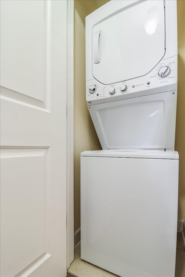 laundry room with stacked washer / drying machine