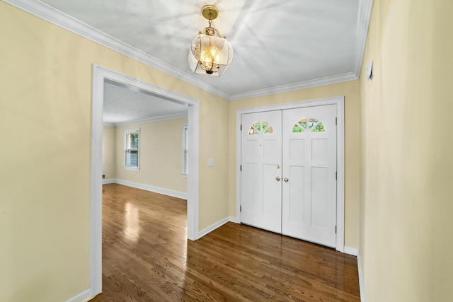 foyer entrance with wood-type flooring and crown molding