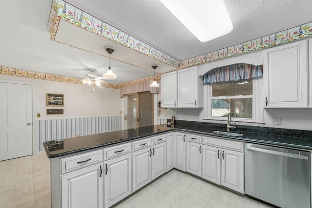 kitchen with dishwasher, white cabinetry, sink, and kitchen peninsula