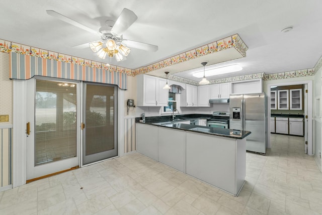 kitchen with white cabinetry, ceiling fan, hanging light fixtures, stainless steel appliances, and kitchen peninsula