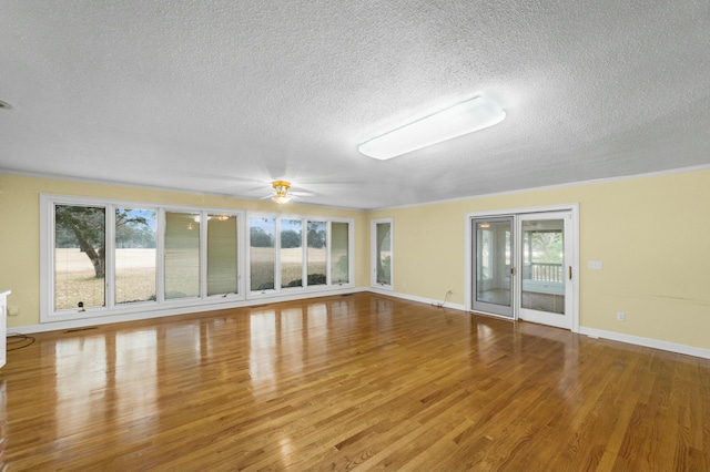 interior space featuring ceiling fan, a textured ceiling, and hardwood / wood-style flooring