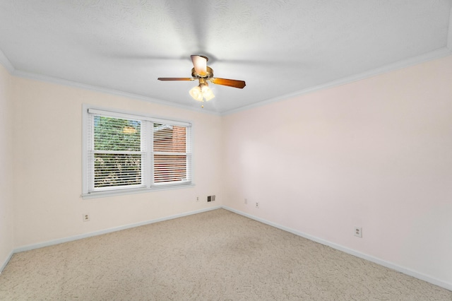 carpeted spare room featuring ceiling fan and ornamental molding