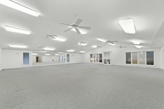 empty room featuring carpet floors and vaulted ceiling