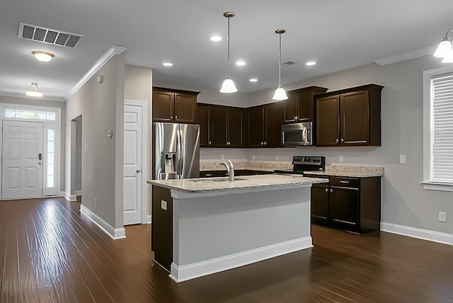 kitchen featuring dark brown cabinetry, ornamental molding, visible vents, appliances with stainless steel finishes, and a sink