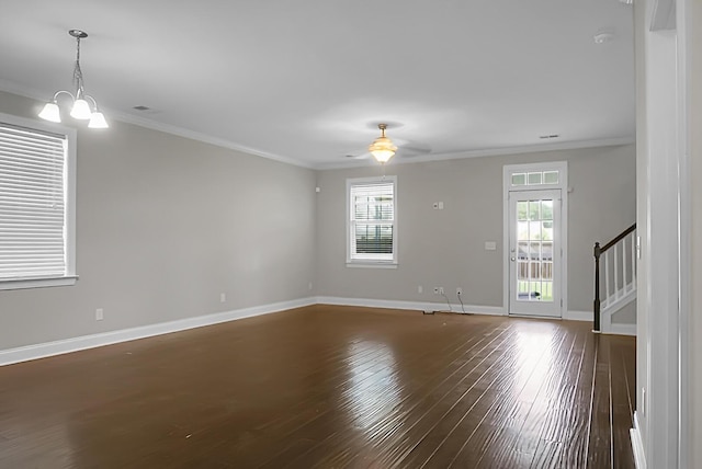 empty room featuring ornamental molding, baseboards, plenty of natural light, and hardwood / wood-style floors