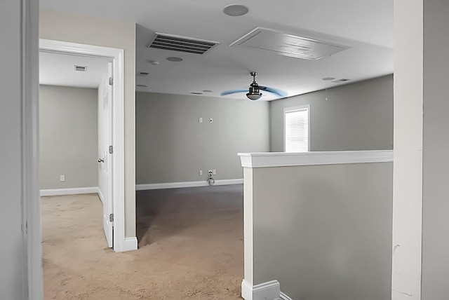 hall featuring attic access, baseboards, and visible vents