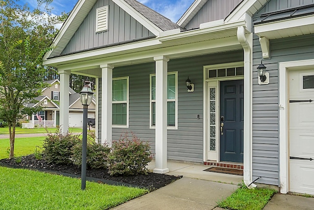 property entrance featuring board and batten siding and covered porch
