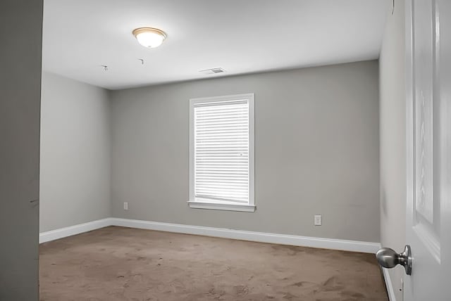 spare room with carpet and baseboards