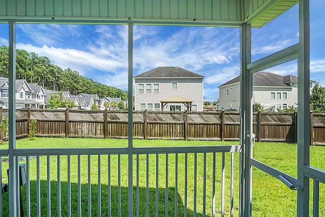 unfurnished sunroom featuring a residential view
