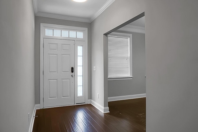 foyer entrance featuring dark wood-style flooring, baseboards, and crown molding
