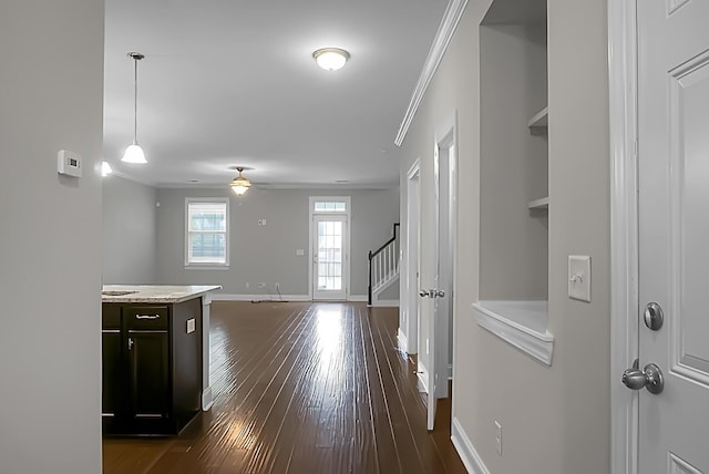 hallway with stairway, dark wood-style flooring, baseboards, and crown molding