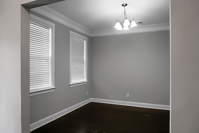 empty room with visible vents, baseboards, an inviting chandelier, dark wood finished floors, and crown molding