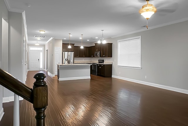 kitchen with dark wood-type flooring, dark brown cabinets, appliances with stainless steel finishes, light countertops, and baseboards